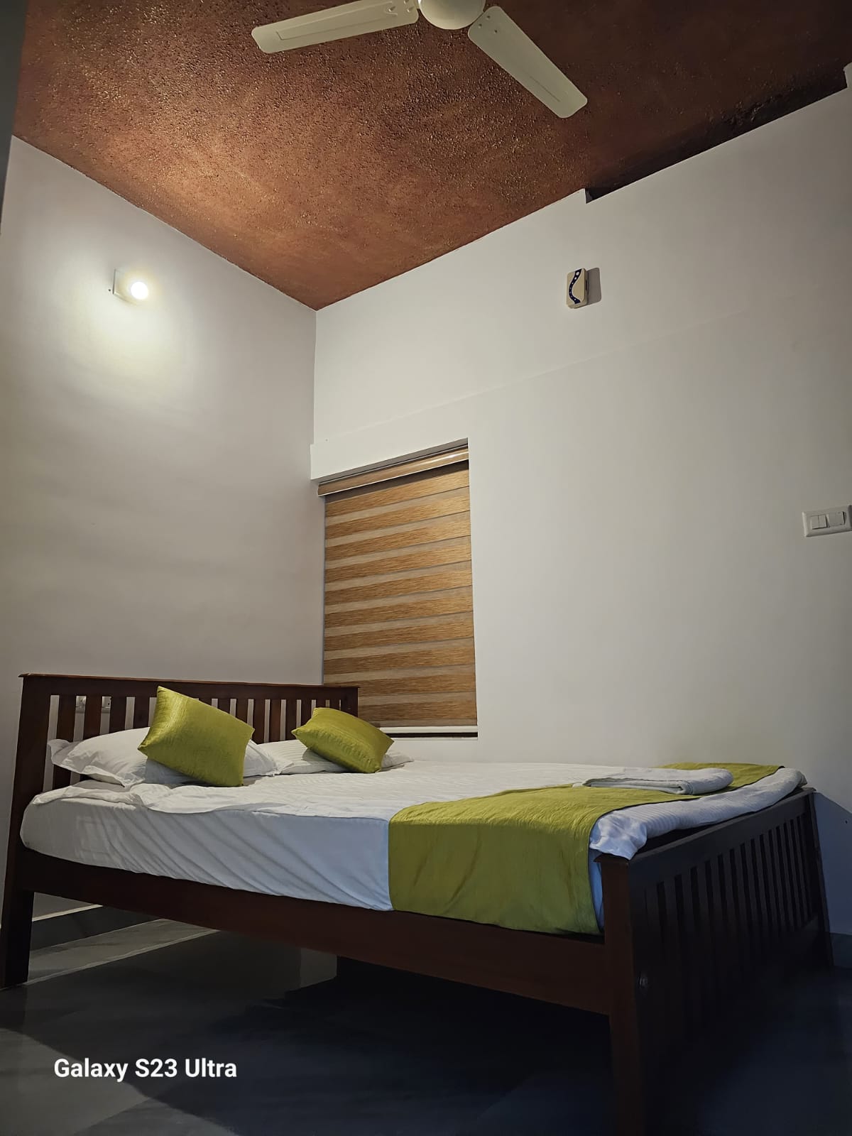 Well-appointed bedroom with attached bathroom and study area in Munnar homestay